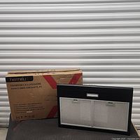 Box showing brand and model plus range hood front with filters