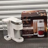 K-Supreme coffee maker next to original box