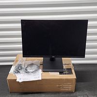 Front view of LG 24MS550 monitor on stand with accessories and box