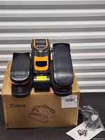 Elliptical machine on box with remote packaged beside