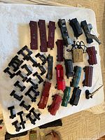 Array of train car bodies, loose trucks and trestle supports on table