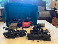 Lot overview showing locomotives, tender, caboose, track bundle, transformers in tote