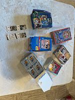 Overview of six opened sports card boxes and bookmarks on table