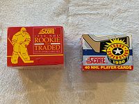 Front view of both sealed Score boxed sets