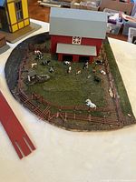 Farm diorama with barn, animals, fence, track pieces