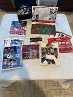 All items spread on table, showing albums, sticker sheets, keychain, booklets, fold-out board