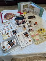 Full lot laid out showing binder, patch, keychains, photo and paper items