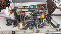 Overall view of assorted tools and sign on table