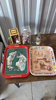 Two Coca-Cola metal trays, glass bottle, polar bear figurines, mini wooden crate with miniature can