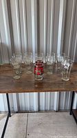 Overview of 11 Coca-Cola glasses on table