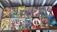 Overview of 16 bagged comic books laid out on table