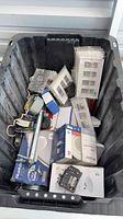 Large tote with boxed light fixtures, wall plates, metal boxes