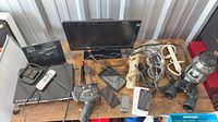 Wide view showing TV, DVD player, tablets, phones, joysticks, binoculars, cables