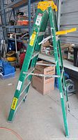 Green fiberglass step ladder front view