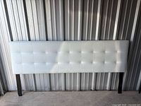 Front view showing white tufted upholstery and overall dimensions