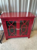 Front view showing two glass doors with geometric overlays and knobs