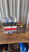 Two stacks of Stephen King books: hardcovers on left, mass-market paperbacks on right