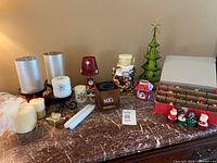 Full lot on tabletop showing variety of Christmas decor and candles