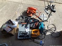 Group shot of all power tools, cases, drill press stand, and accessory box