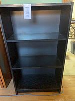 Front view showing entire bookcase and three shelves