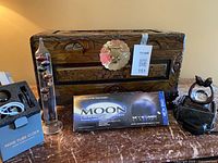 Group shot showing chest, thermometer, nixie clock box, Moon kit box, crystal orb on base