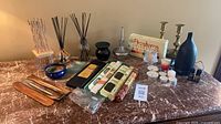 Overall lot with incense, diffusers, candles, holders on tabletop