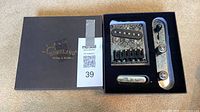 Box with Homeland branding and open insert showing bridge, neck pickup, control plate