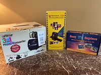 All three boxed devices on table