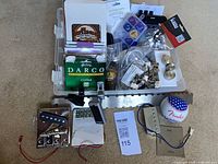 Overall lot layout showing organizer with parts, strings, hardware, baseball and pillow