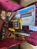 Overall lot in magenta bin showing Mastercraft carving set, ROK chisel set, coping saw, plane, saw, loose chisels, finials, wood-burning kit