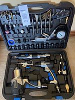 Open case showing full 100-piece Mastercraft pneumatic tool kit and accessories