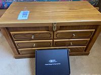 Closed oak chest with four visible drawers and Vision Aid box