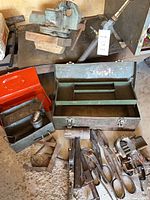 Overhead view of entire lot: bench vise, three toolboxes, assorted hand tools and oil can