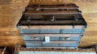 Top view of steamer trunk showing wood slats, canvas, hardware