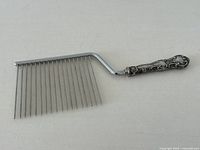 Full view of cake breaker showing handle, shaft and tines