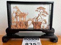 Front view of cork diorama in glass case on stand