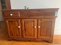 Front view showing entire pine dry sink cabinet, three doors, drawer, top surface