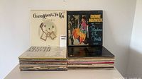 Stack of approx. 40 LPs with two albums displayed on top