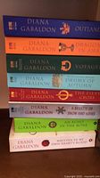Stack of all eight Outlander series paperbacks showing spines and titles