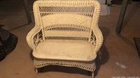 Front view of ivory wicker loveseat