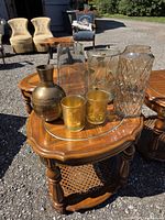 All six gold and clear glass vases grouped on table outdoors