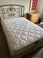 Bed assembled showing headboard, mattress and skirt