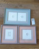 Group shot of three framed embossed prints