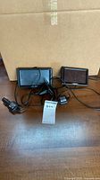 Two Garmin GPS units with cables and mount
