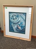 Full view of framed print leaning against wall