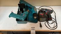 Three cordless drills, two chargers and blue toolbox overview