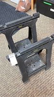 Front angled view of both Stanley plastic saw horses