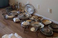 Full group of assorted silver-plated hollowware on floor