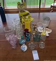 Full lot showing metal cat candle holder and assortment of vases
