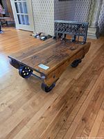 Full view of grain scale cart showing wood platform, iron wheels and lattice back